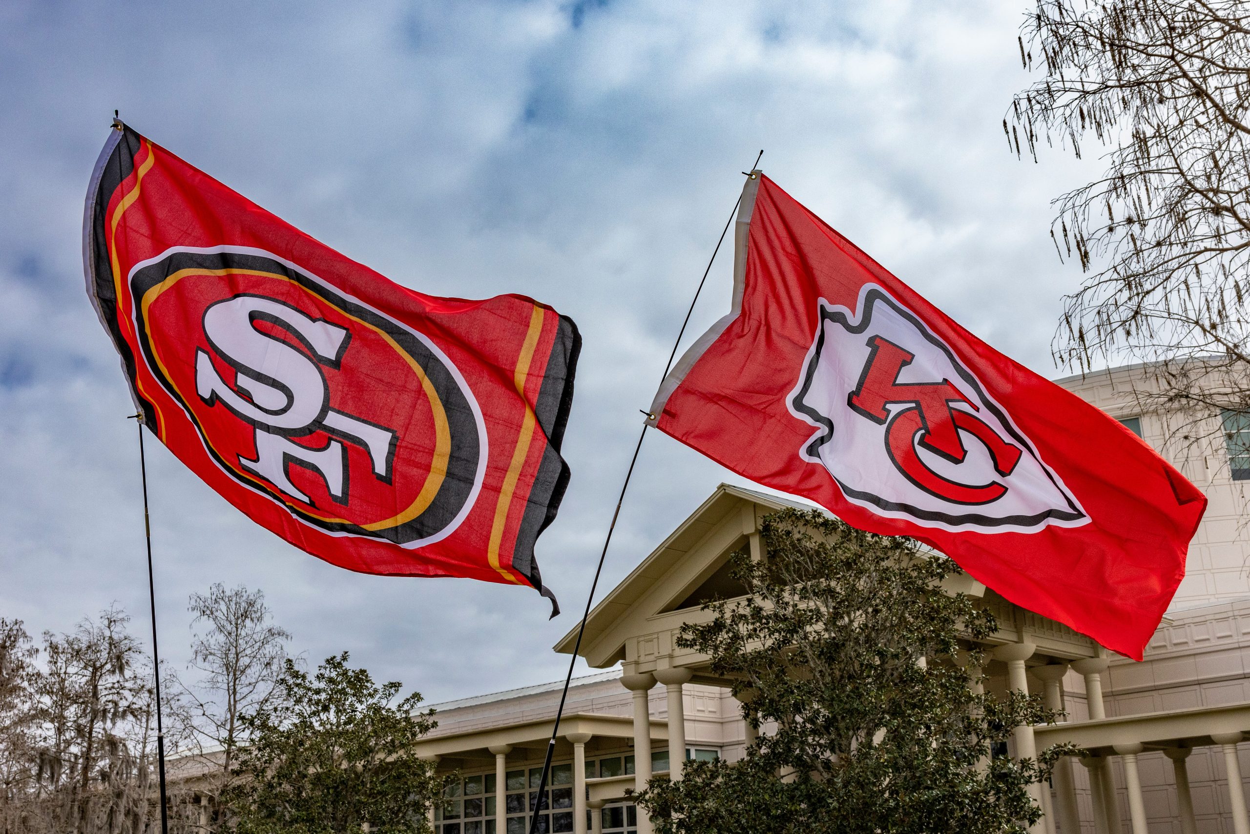 Two flags flying side by side, SF 49ers and KC chiefs
